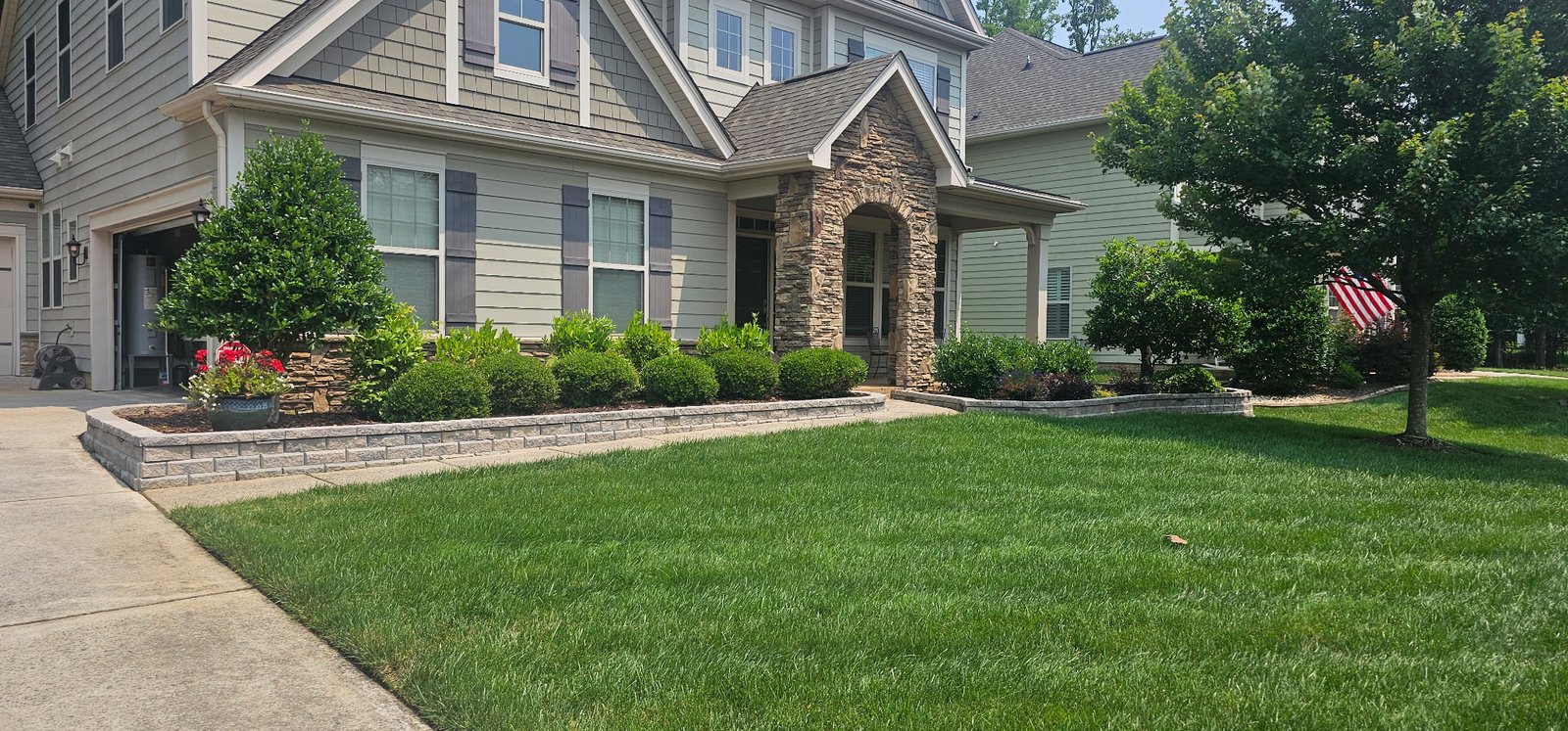 Landscape cleanup with new mulch and shrub trimming in Charlotte